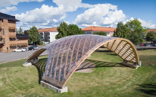 A timber and polycarbonate deployable grid shell