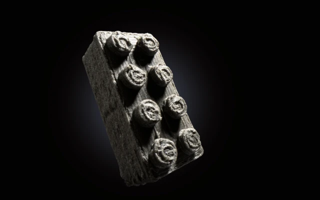 Building on the moon with LEGO bricks made of meteorites